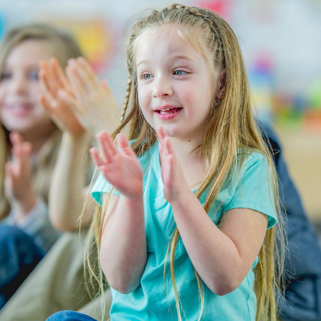 young girl clapping